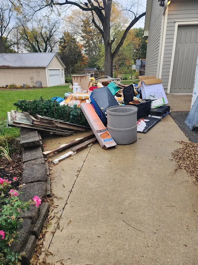 Dumpster being loaded with debris for Estate Cleanout Dumpster Rental in Washington